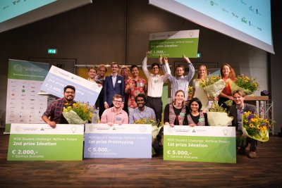 Image showing winners of a challenge with big, novelty cheques